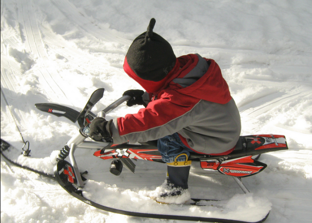 Kid on steerable sled, sledding safety