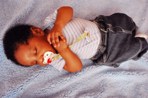 baby sleeps on back with pacifier